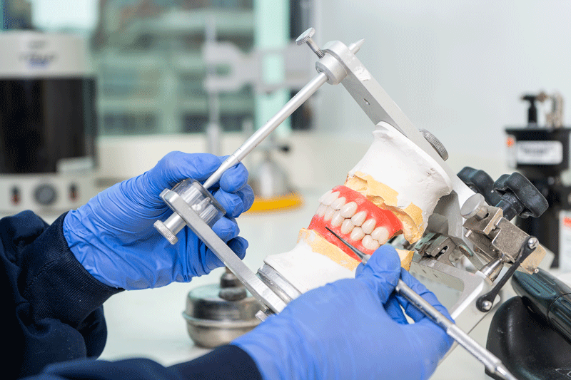 a beneficial all-on-x dental implant prosthesis being milled for a patients all-on-x dental implant surgery.