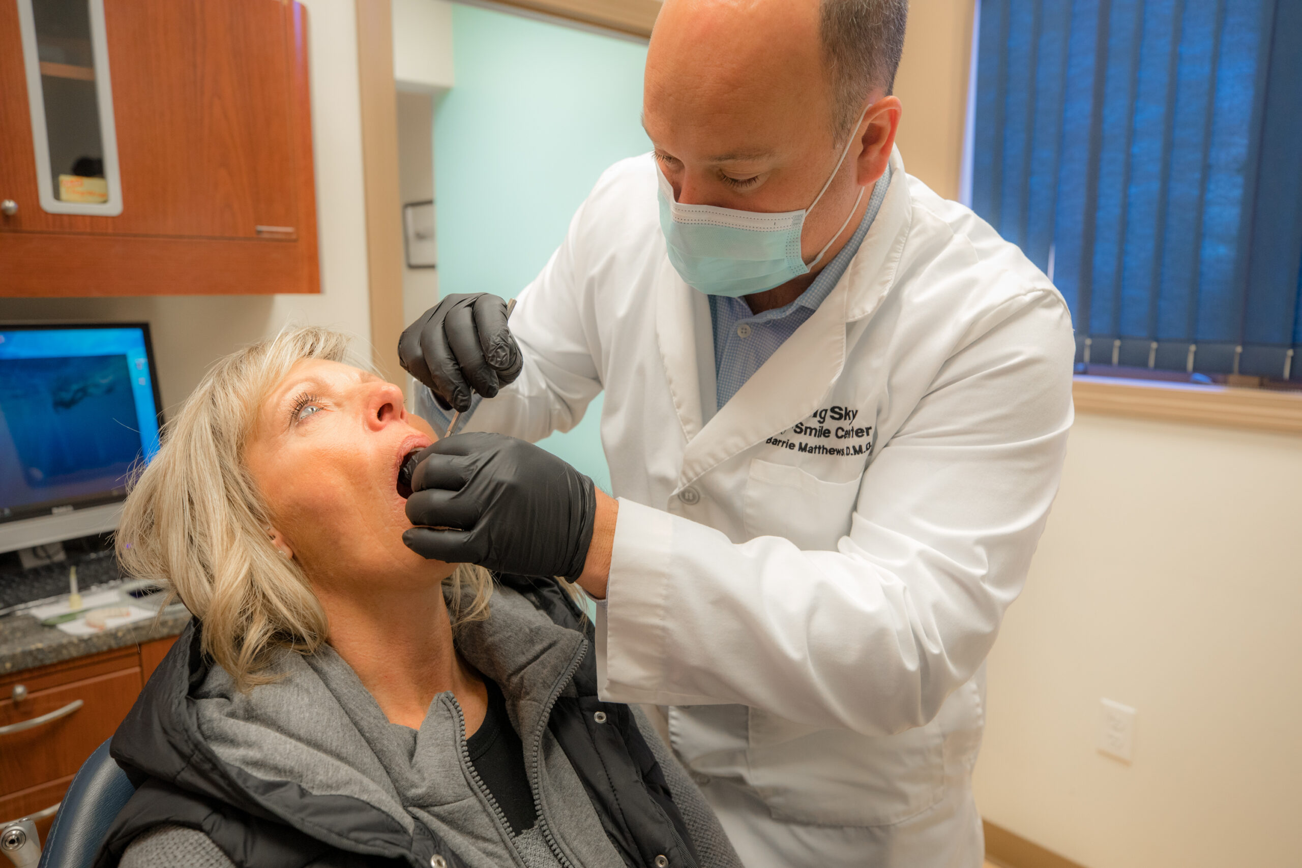 Dr. Barrie Matthews determining if a patient is qualified to get treated with All-On-X dental implants.