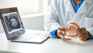 Dentist and patient examining a dental implant model in a modern office setting